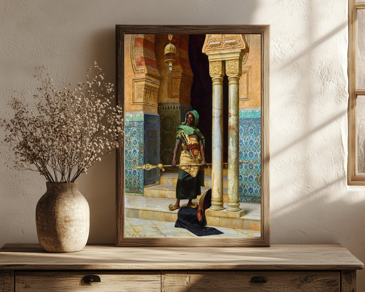 Framed art print of The Nubian Guard by Ludwig Deutsch, in a dark wood frame leaning on a rustic console beside dried flowers
