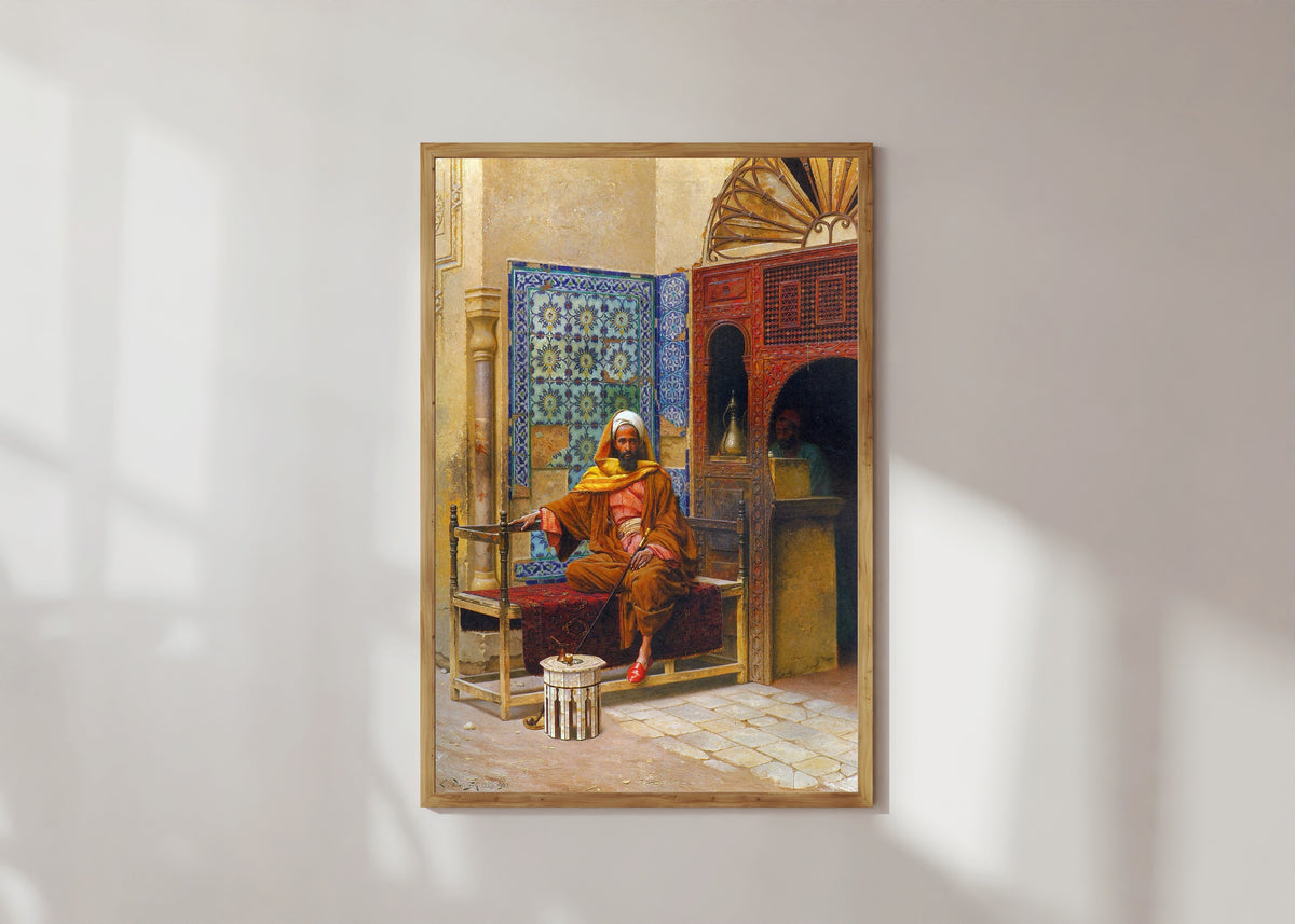 Framed art print of The Smoker by Ludwig Deutsch, in a light wood frame on a sunlit white wall