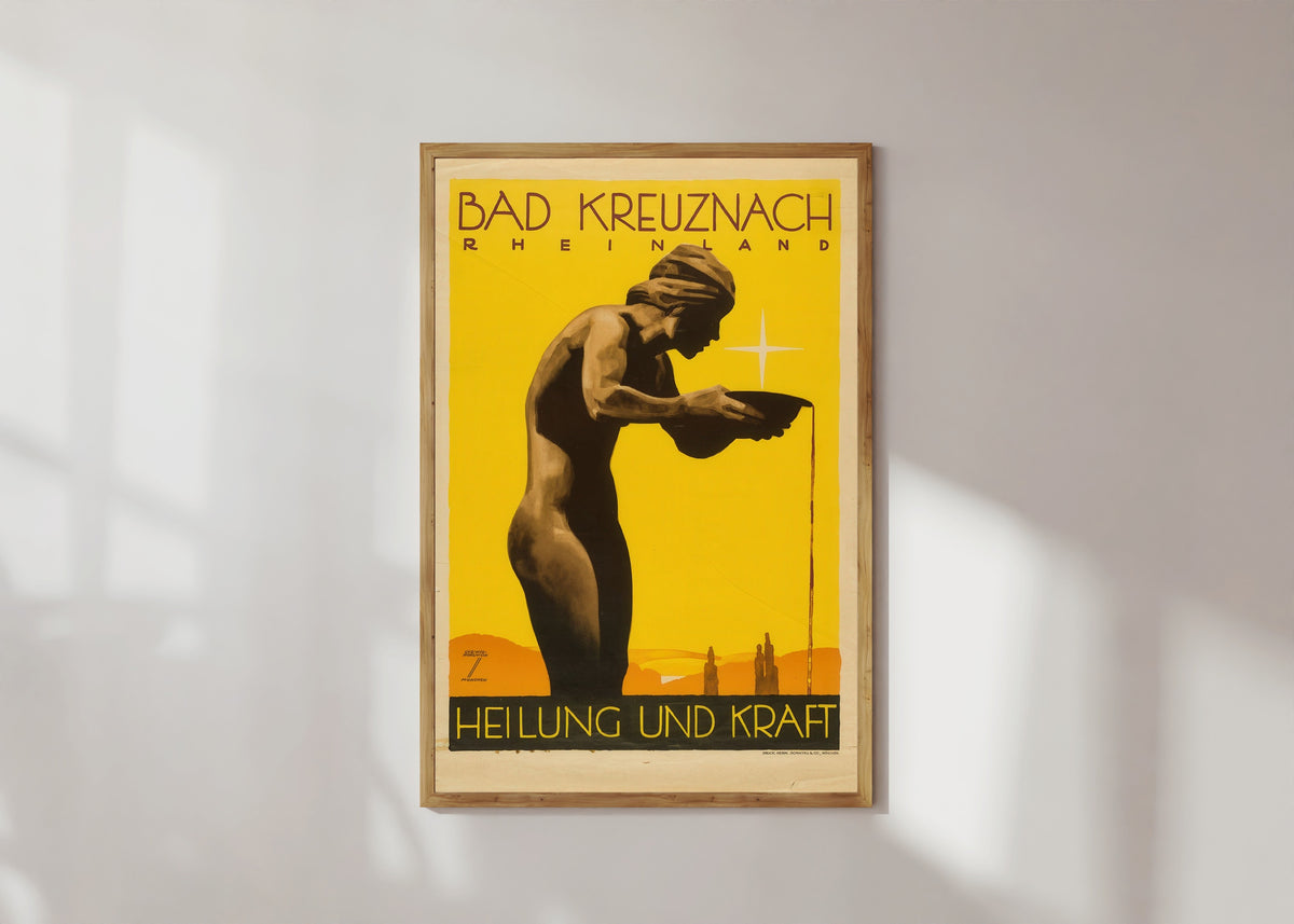 Framed art print of Bad Kreuznach by Ludwig Hohlwein, in a light wood frame on a sunlit white wall