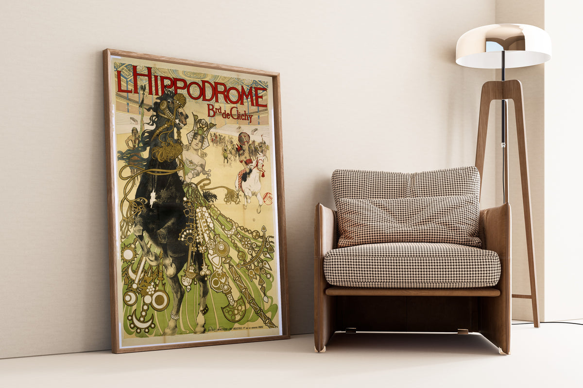 L'Hippodrome, Boulevard de Clichy by Manuel Orazi — framed and leaning against a wall beside an armchair and a floor lamp