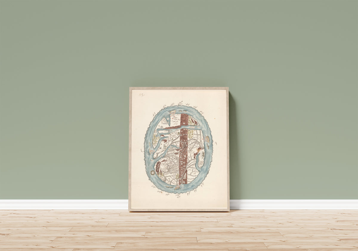 Framed art print of Map of the Islamic World, in a light wood frame leaning on a sage green wall above a wooden floor