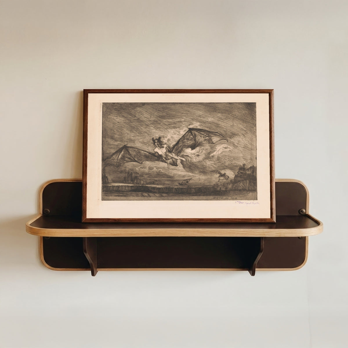 Framed art print of The Nightbeast by Marcel Roux, in a dark wood frame resting on a wall shelf
