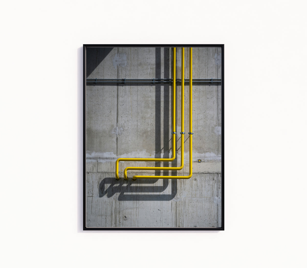 Framed art print of Light and Shadow II by Marcus Lenk, in a slim black frame on a plain white wall