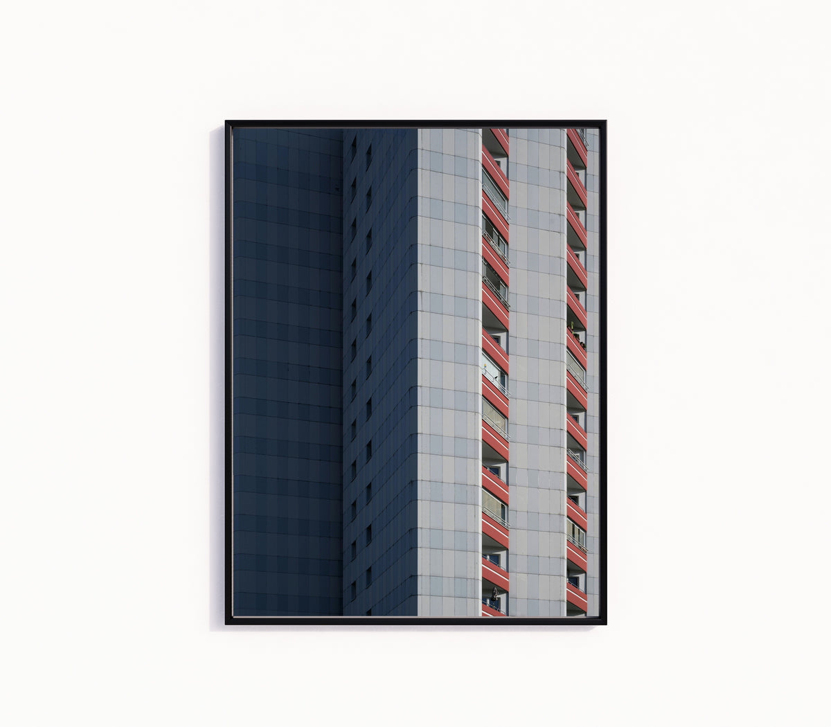 Framed art print of Light and Shadow III by Marcus Lenk, in a slim black frame on a plain white wall