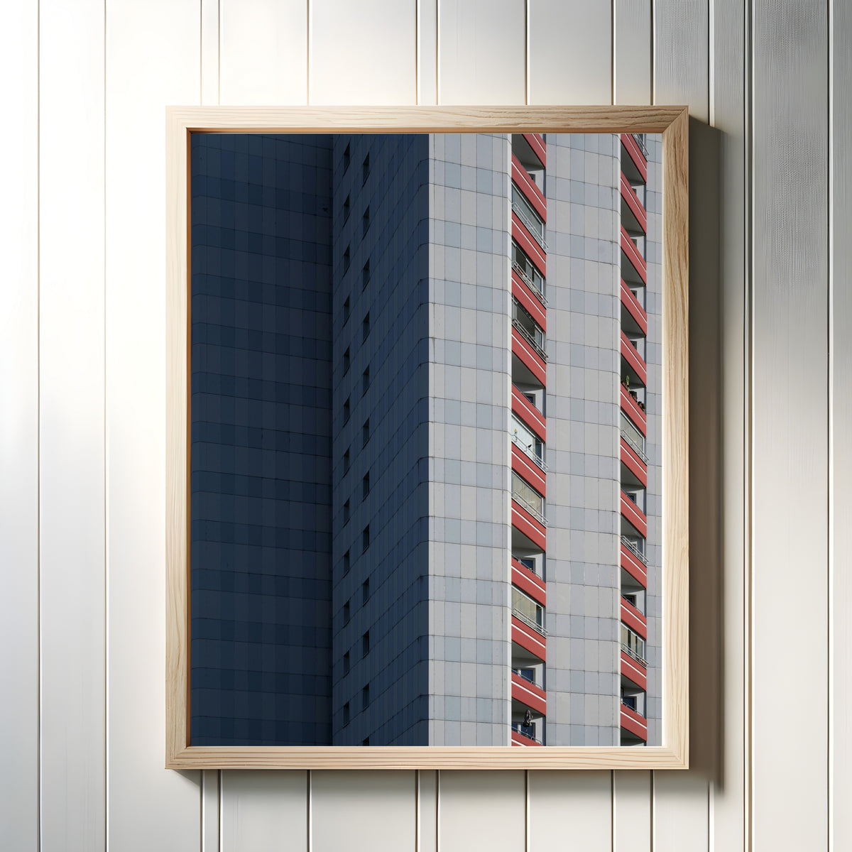 Framed art print of Light and Shadow III by Marcus Lenk, in a light wood frame on a white panelled wall