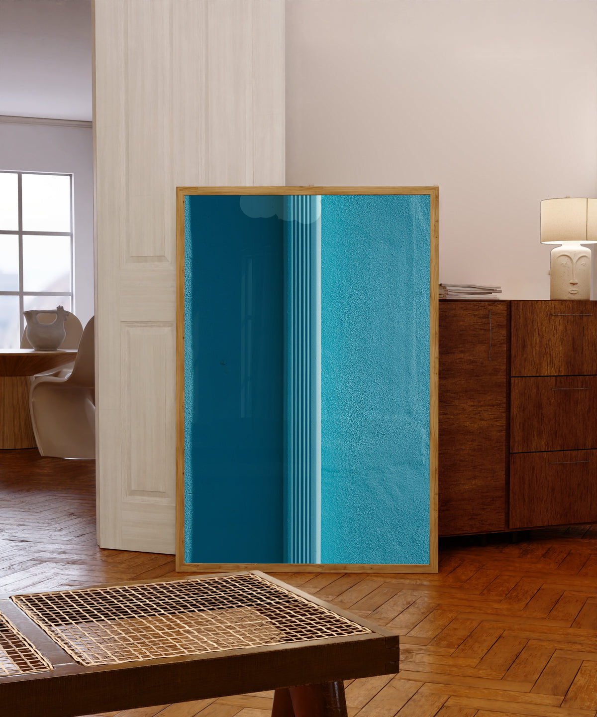 Framed art print of Light and Shadow VII by Marcus Lenk, in a light wood frame leaning in a warm room with a parquet floor