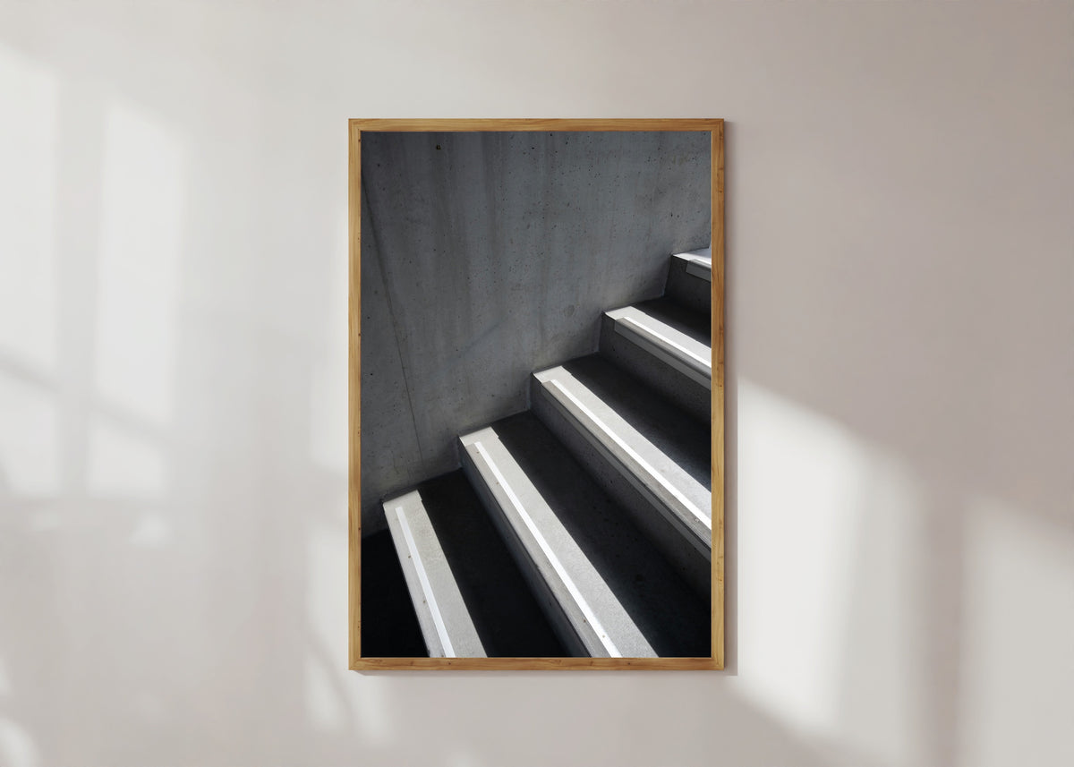 Framed art print of Light and Shadow VIII by Marcus Lenk, in a light wood frame on a sunlit white wall