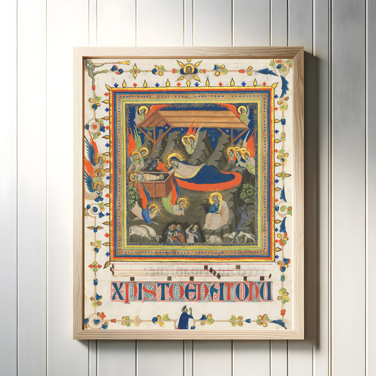 Framed art print of The Nativity with the Annunciation to the Shepherds by Master of the Dominican Effigies, in a light wood frame on a white panelled wall