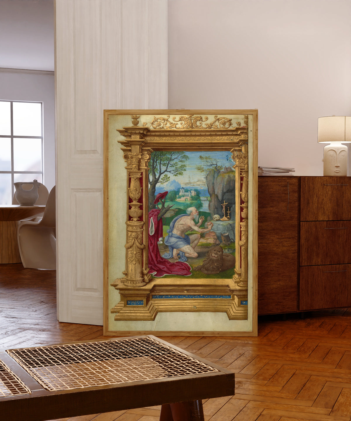 Framed art print of Saint Jerome by Master of the Getty Epistles, in a light wood frame leaning in a warm room with a parquet floor