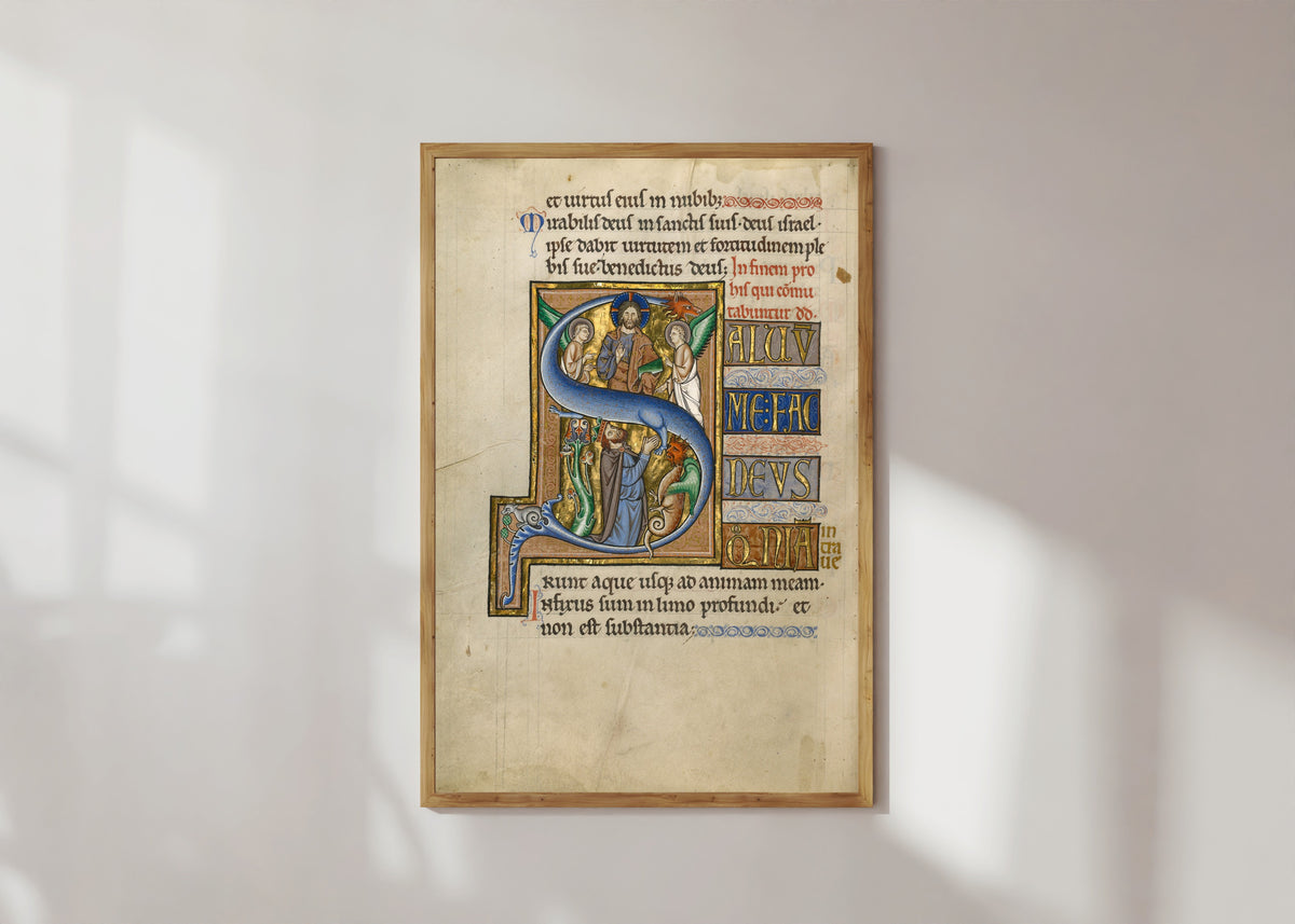 Framed art print of Initial S: David in Prayer by Master of the Ingeborg Psalter, in a light wood frame on a sunlit white wall