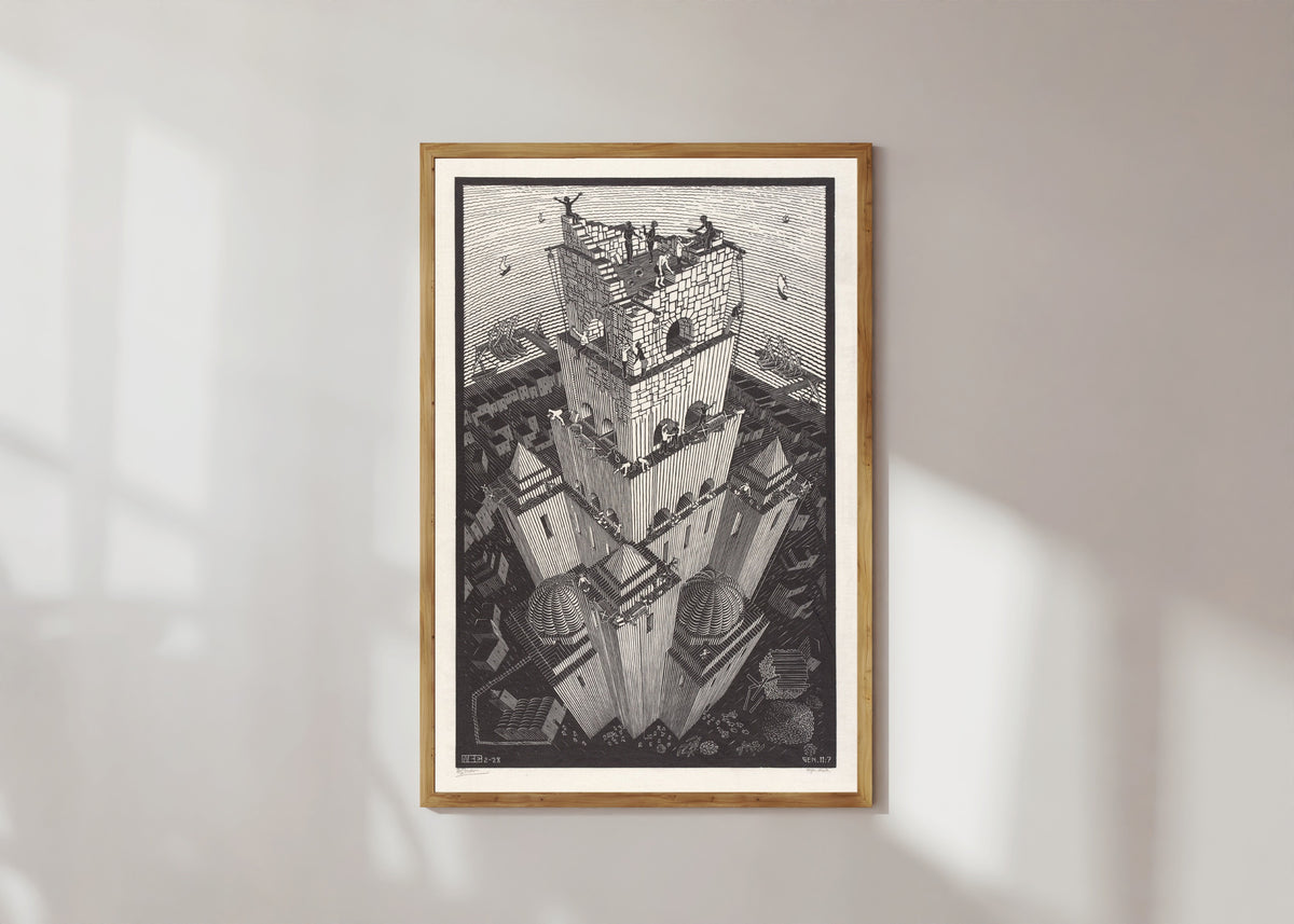 Framed art print of The Tower of Babel by M.C. Escher, in a light wood frame on a sunlit white wall