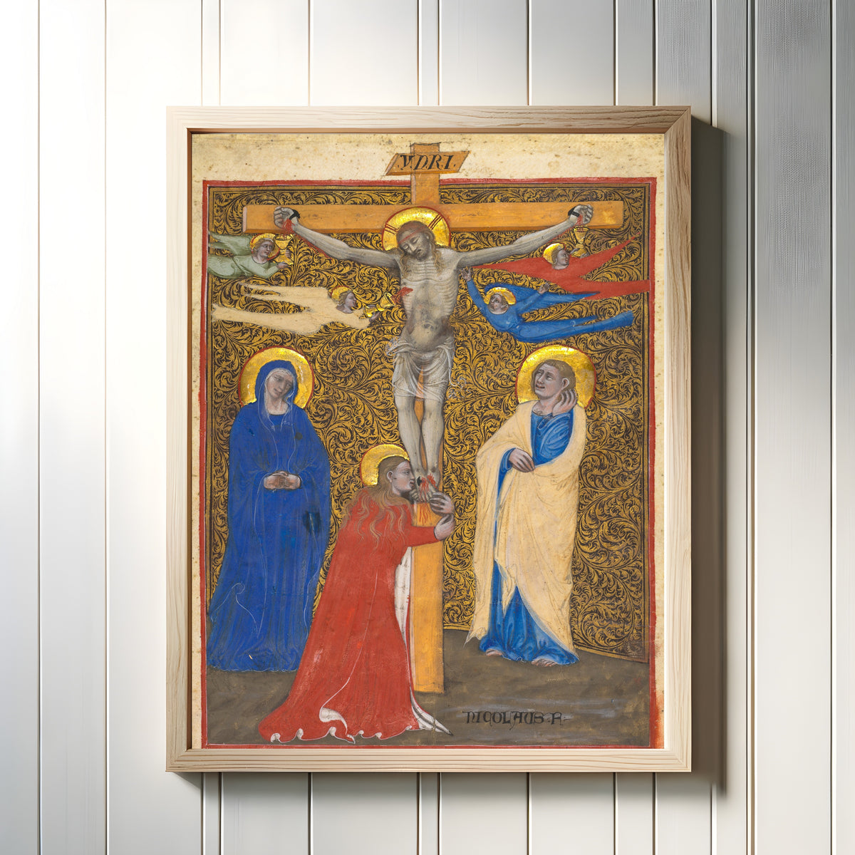 Framed art print of The Crucifixion by Niccolò di Giacomo da Bologna, in a light wood frame on a white panelled wall
