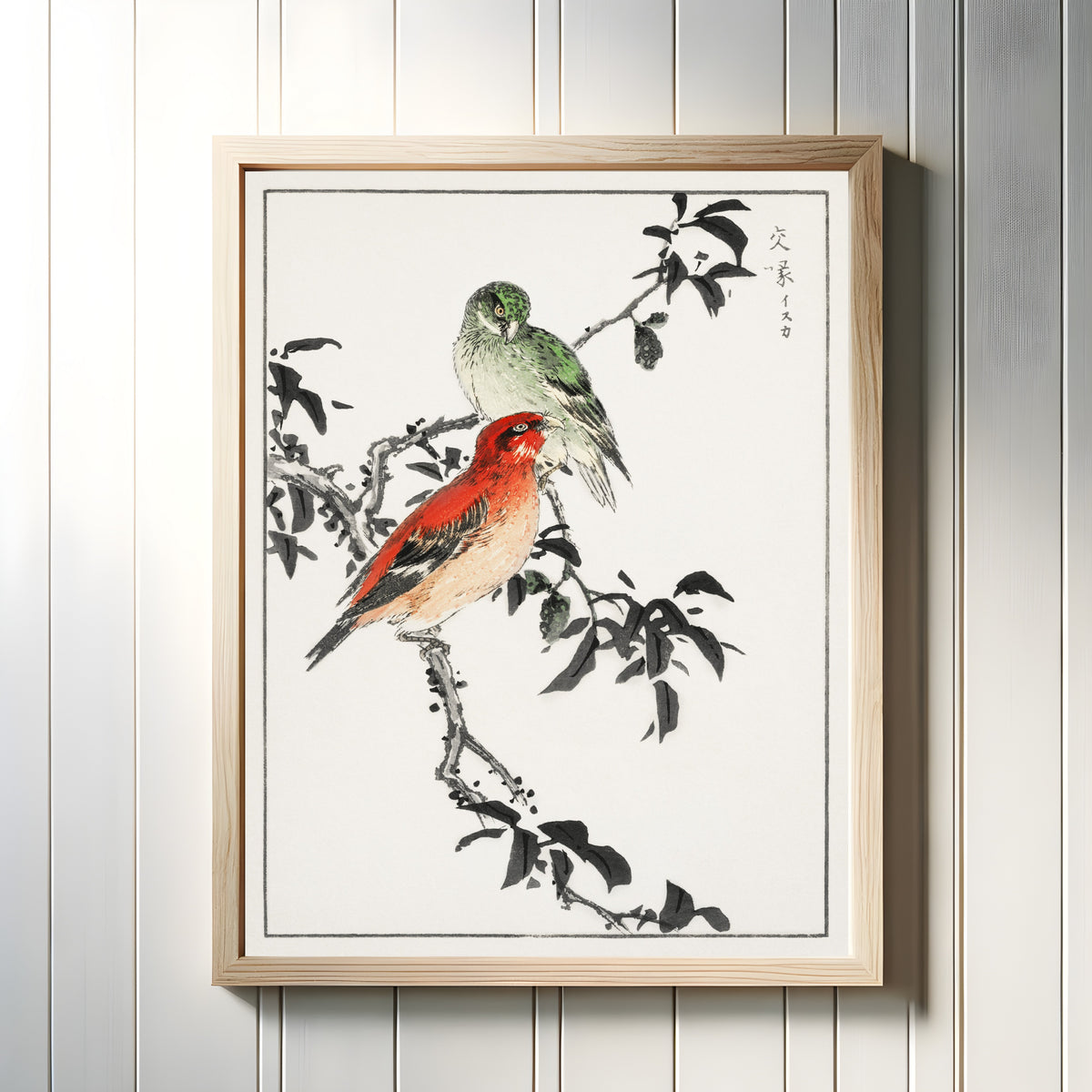 Framed art print of Crossbill by Numata Kashū, in a light wood frame on a white panelled wall