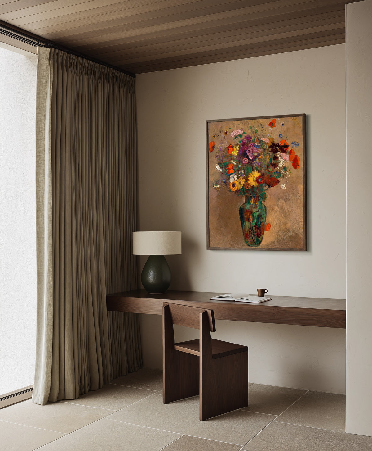 Framed art print of Large Bouquet of Wildflowers by Odilon Redon, in a dark wood frame on a plaster wall above a walnut desk