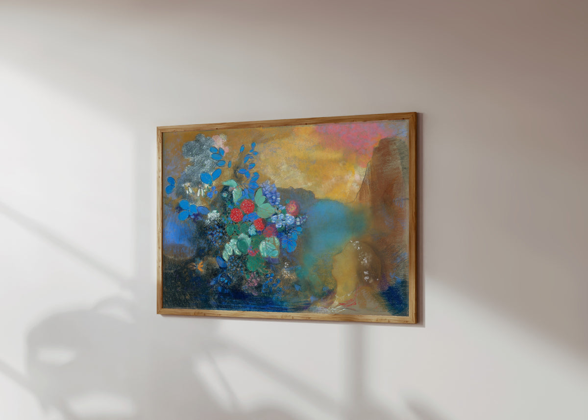 Framed art print of Ophelia Among the Flowers (c. 1905) by Odilon Redon, in a light wood frame on a sunlit white wall, seen at a slight angle