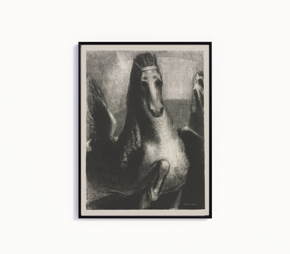 Framed art print of The Wing by Odilon Redon, in a slim black frame on a plain white wall