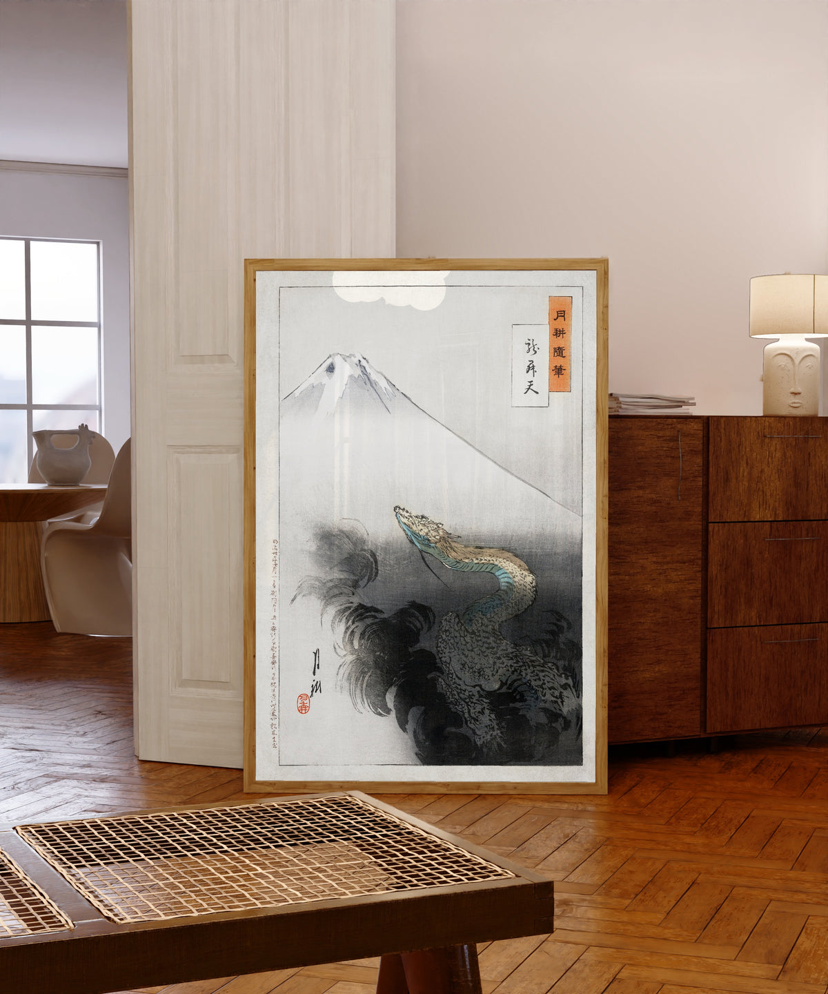Framed art print of Ryū shōten (1897) by Ogata Gekkō, in a light wood frame leaning in a warm room with a parquet floor
