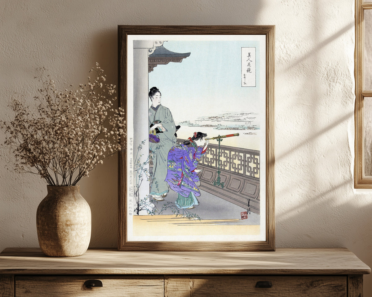 Framed art print of The Binoculars (1887–1896) by Ogata Gekkō, in a dark wood frame leaning on a rustic console beside dried flowers