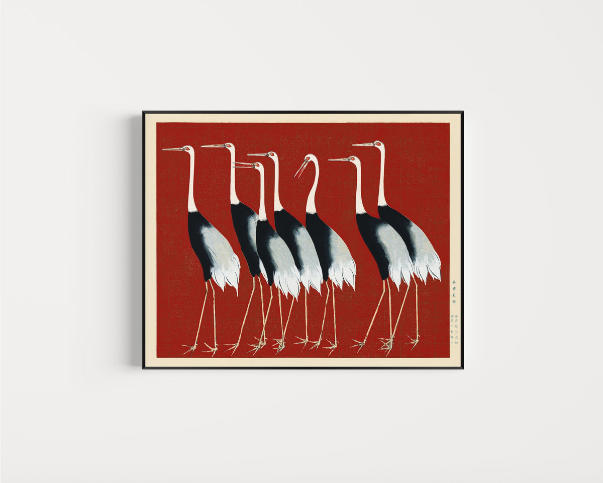 Framed art print of Cranes in Red by Ogata Korin, in a slim black frame on a plain white wall