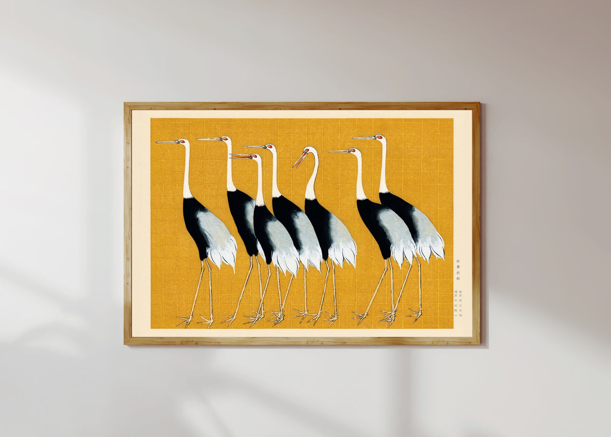 Framed art print of Cranes by Ogata Korin, in a light wood frame on a sunlit white wall