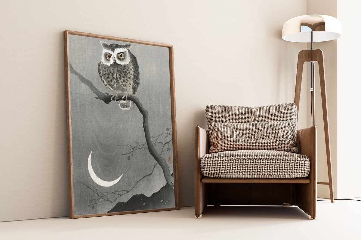 Long-eared Owl on Bare Tree Branch by Ohara Koson — framed and leaning against a wall beside an armchair and a floor lamp