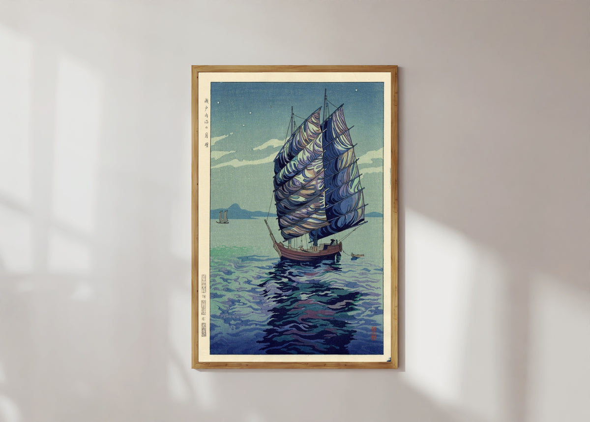 Framed art print of Moonlight Over Inland Sea by Okazaki Shintaro, in a light wood frame on a sunlit white wall