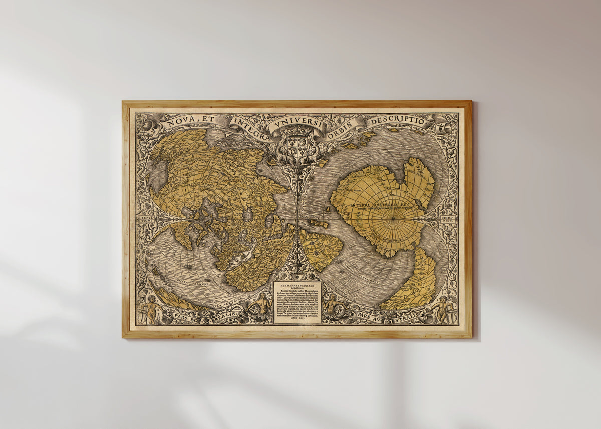 Framed art print of Nova et Integra Universi Orbis Descriptio by Oronce Finé, in a light wood frame on a sunlit white wall