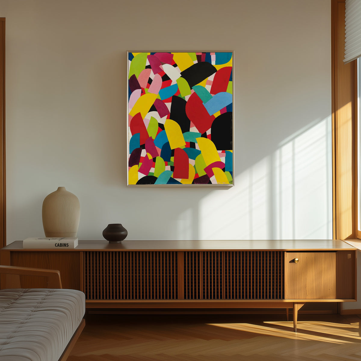 Framed art print of Untitled (1936) by Otto Freundlich, in a thin light frame on a sunlit wall above a wooden sideboard