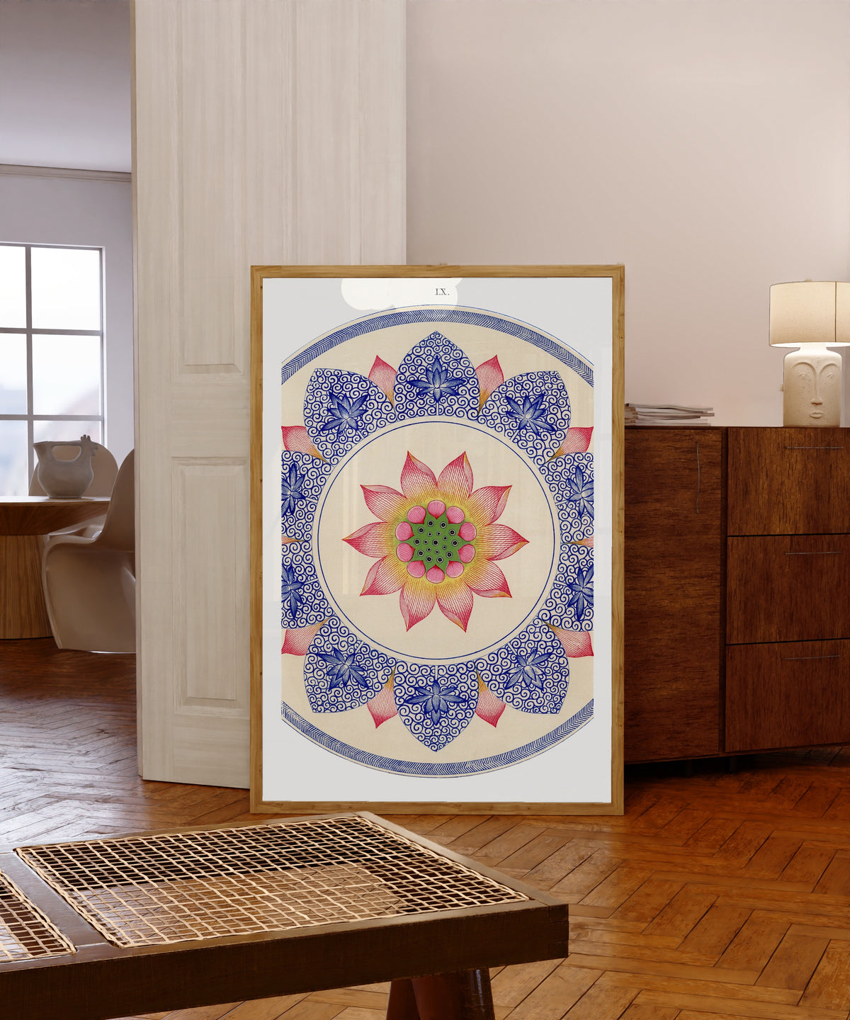 Framed art print of Examples of Chinese Ornament, Plate 60 by Owen Jones, in a light wood frame leaning in a warm room with a parquet floor