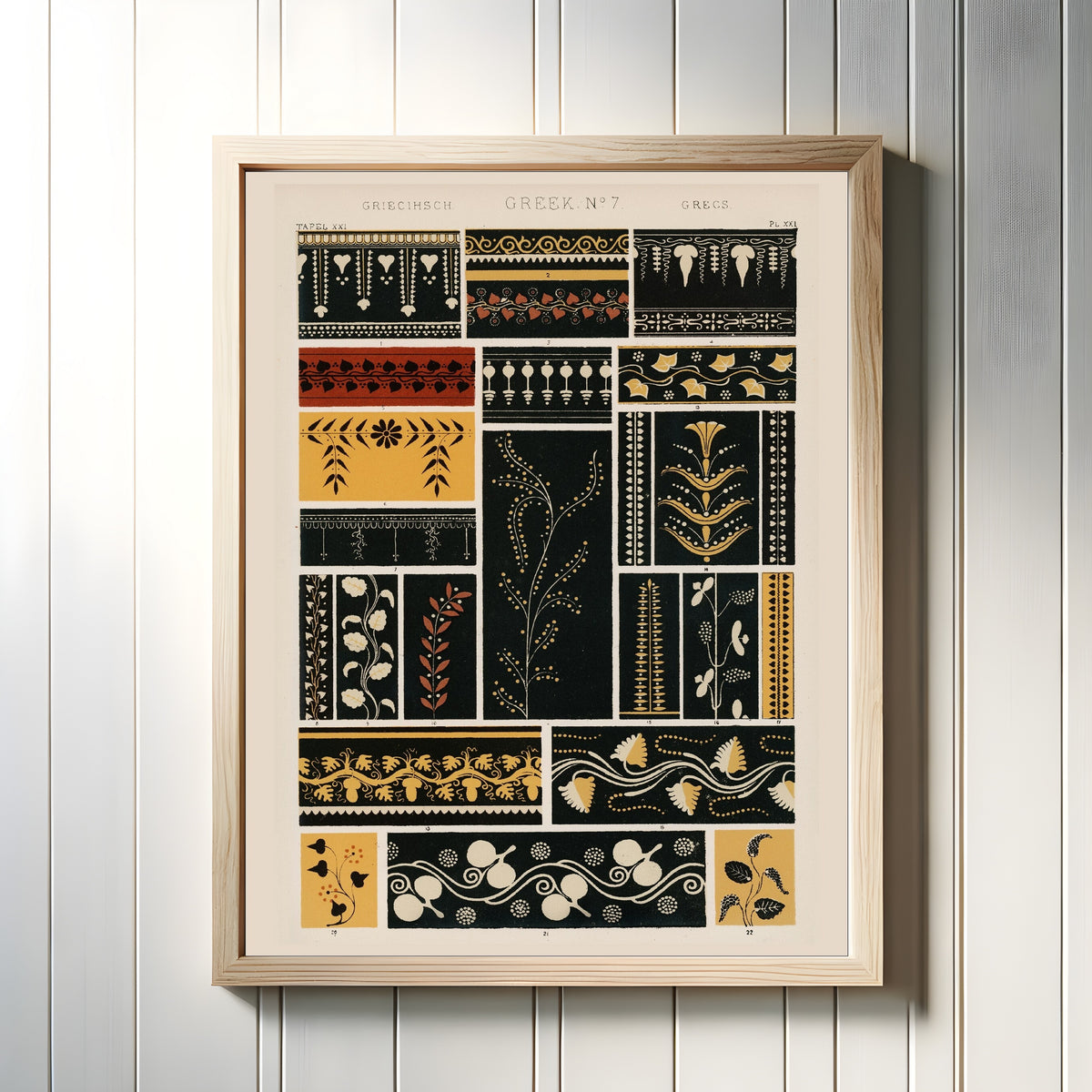 Framed art print of Greek by Owen Jones, in a light wood frame on a white panelled wall