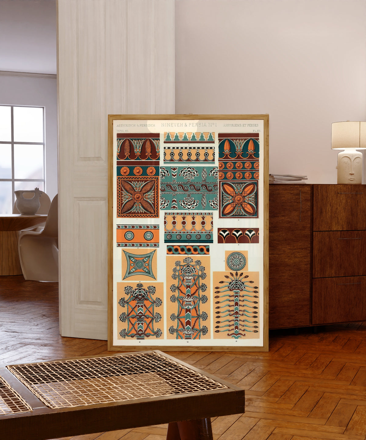 Framed art print of Nineveh & Persia No. 1 by Owen Jones, in a light wood frame leaning in a warm room with a parquet floor