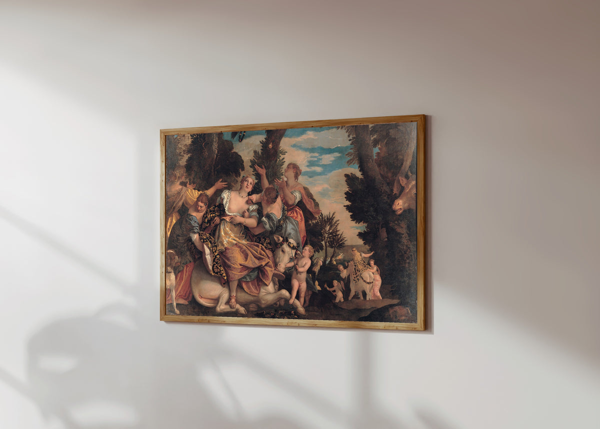 Framed art print of Rape of Europa by Paolo Veronese, in a light wood frame on a sunlit white wall, seen at a slight angle