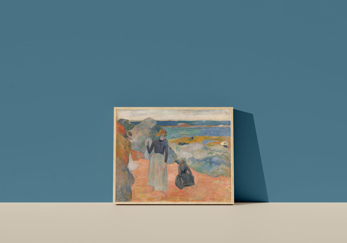 Framed art print of At the Beach, Bretagne by Paul Gauguin, in a light wood frame leaning on a blue wall