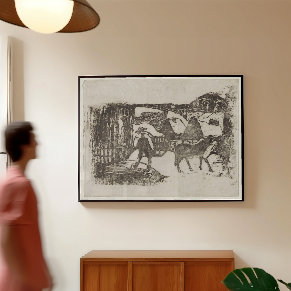 Framed art print of The Ox Cart (Le Char à boeufs) by Paul Gauguin, in a slim black frame on a warm wall in a sunlit room
