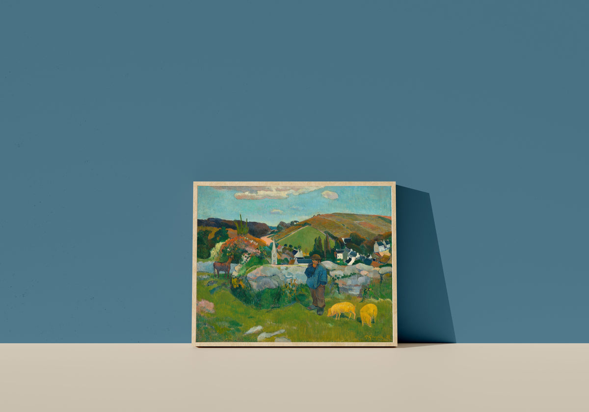 Framed art print of The Swineherd by Paul Gauguin, in a light wood frame leaning on a blue wall