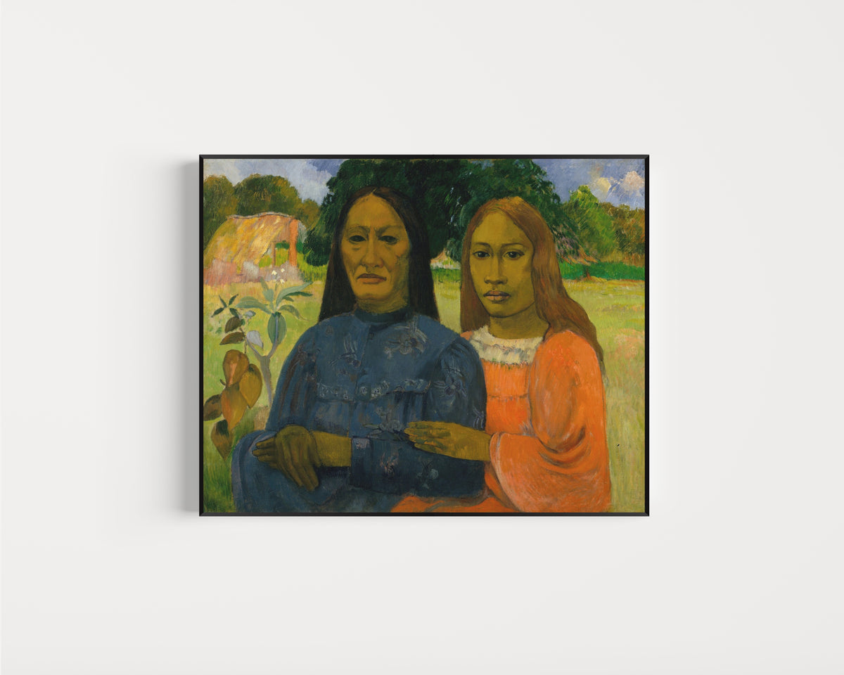 Framed art print of Two Women by Paul Gauguin, in a slim black frame on a plain white wall