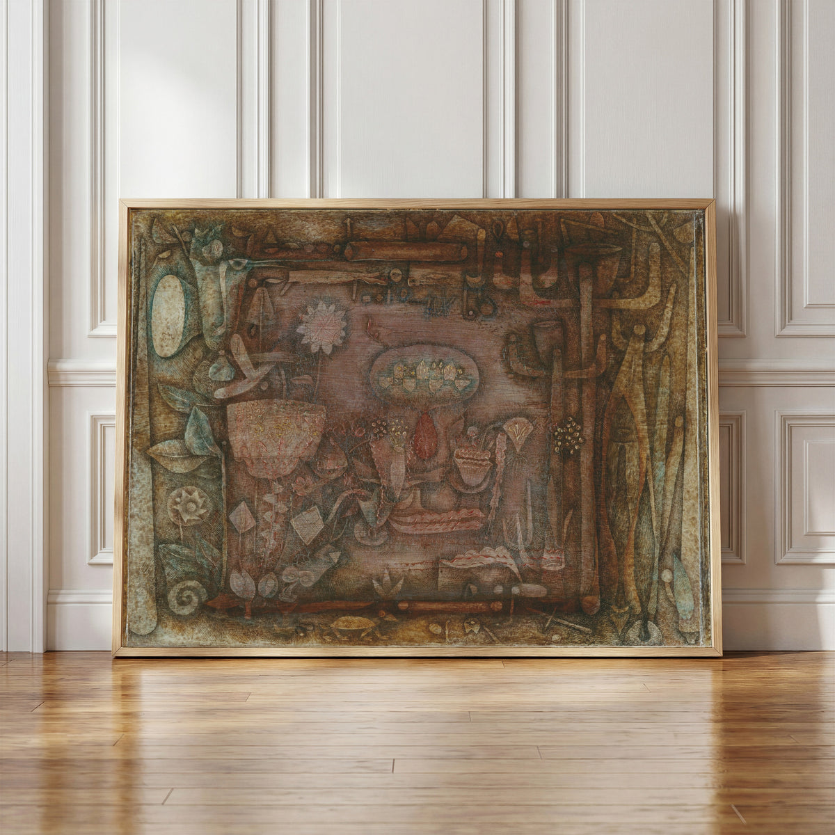 Framed art print of Botanical Theater by Paul Klee, in a light wood frame leaning against a panelled white wall
