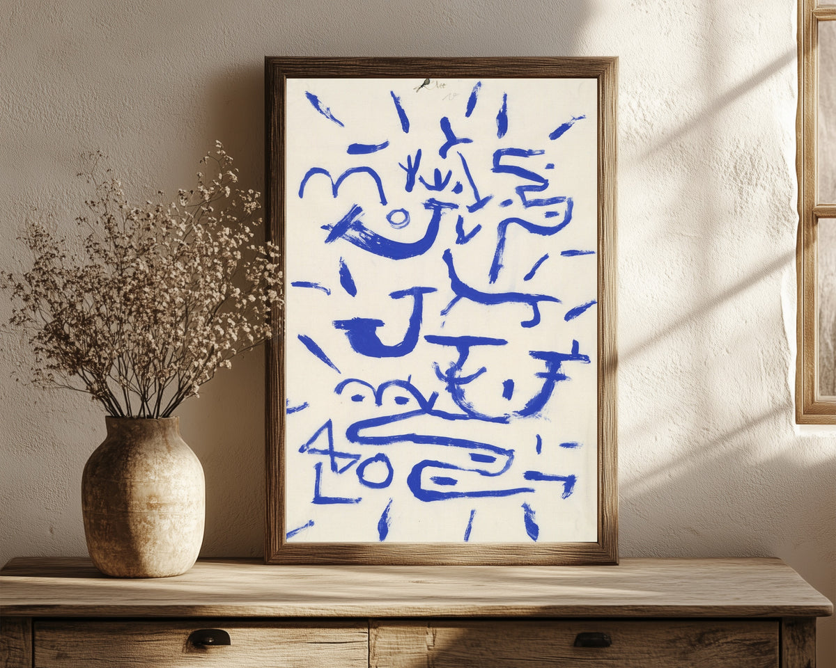 Framed art print of Creeper and Climber by Paul Klee, in a dark wood frame leaning on a rustic console beside dried flowers