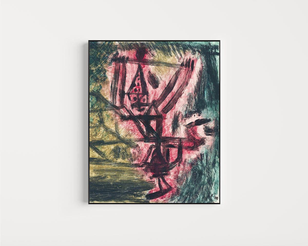Framed art print of Fire Clown by Paul Klee, in a slim black frame on a plain white wall