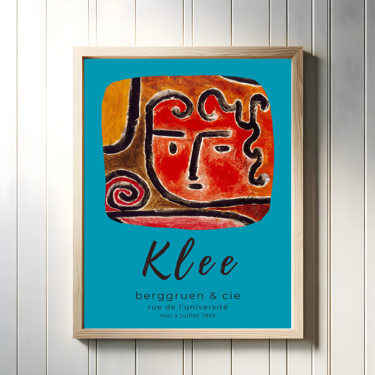 Framed art print of Hot Blooded Girl by Paul Klee, in a light wood frame on a white panelled wall