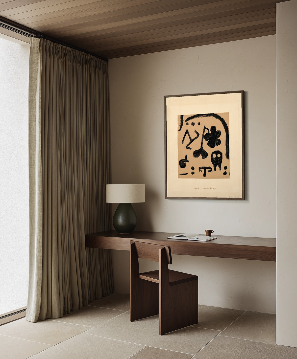 Framed art print of Marks for Later by Paul Klee, in a dark wood frame on a plaster wall above a walnut desk