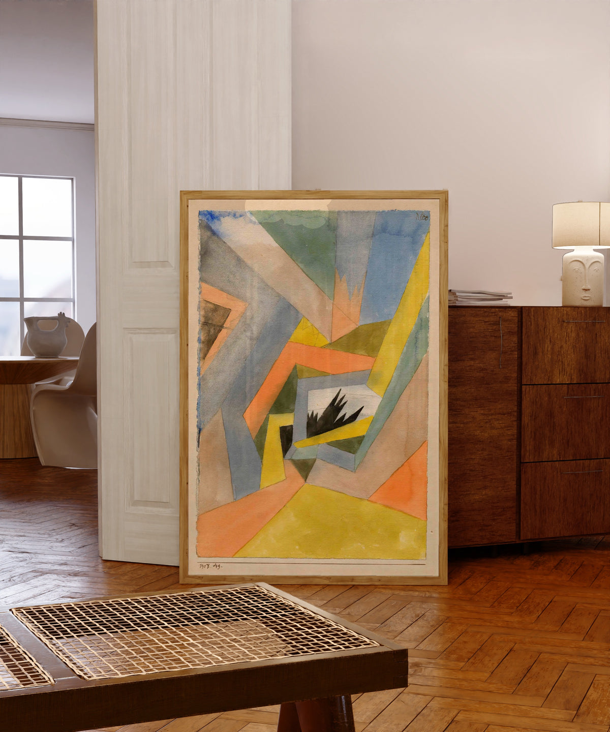 Framed art print of The Idea of Firs by Paul Klee, in a light wood frame leaning in a warm room with a parquet floor
