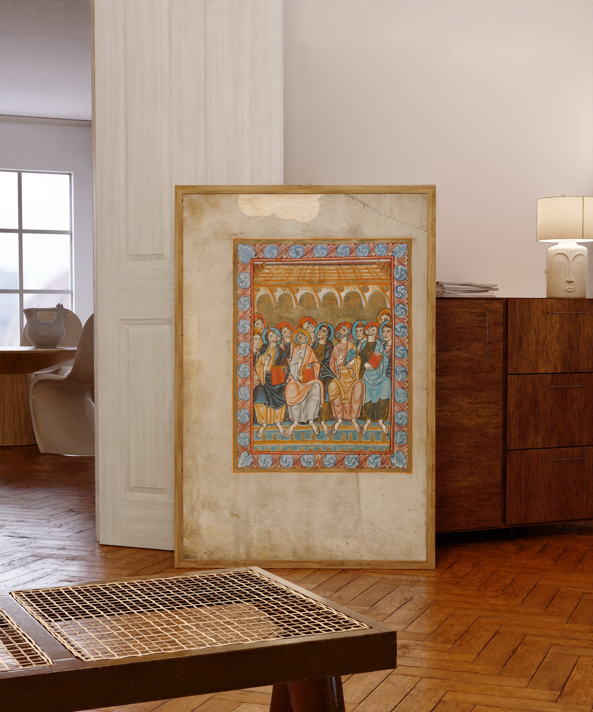 Framed art print of Pentecost (Tongues of Fire), in a light wood frame leaning in a warm room with a parquet floor