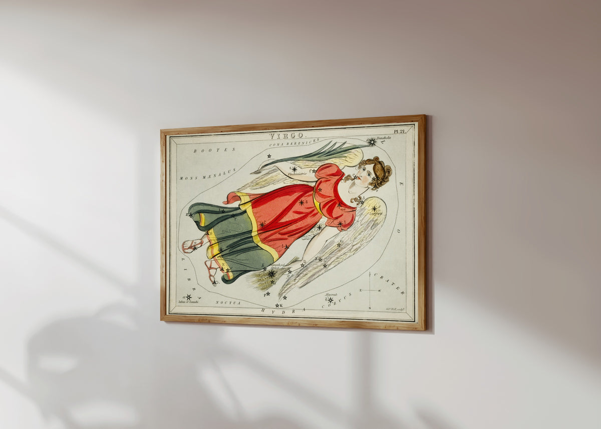 Framed art print of Virgo by Sidney Hall, in a light wood frame on a sunlit white wall, seen at a slight angle