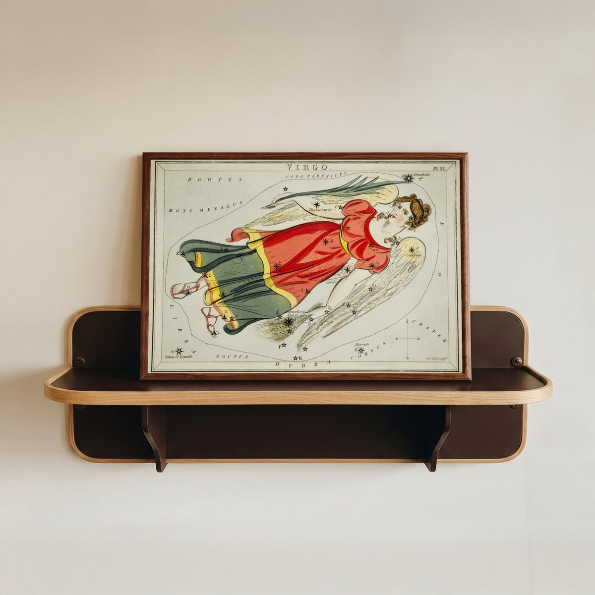 Framed art print of Virgo by Sidney Hall, in a dark wood frame resting on a wall shelf