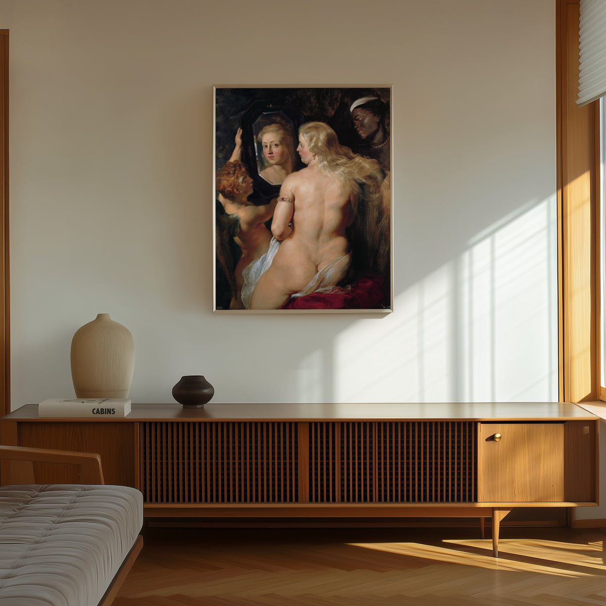 Framed art print of The Toilet of Venus by Peter Paul Rubens, in a thin light frame on a sunlit wall above a wooden sideboard