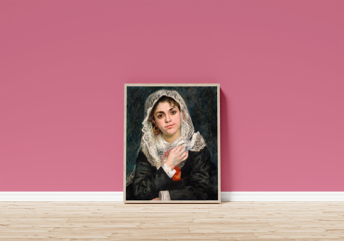 Framed art print of Lise in a White Shawl by Pierre-Auguste Renoir, in a light wood frame leaning on a pink wall above a wooden floor