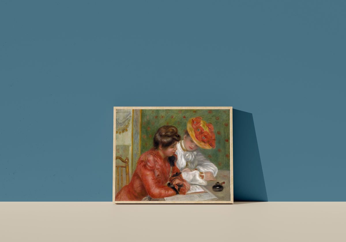 Framed art print of The Letter by Pierre-Auguste Renoir, in a light wood frame leaning on a blue wall