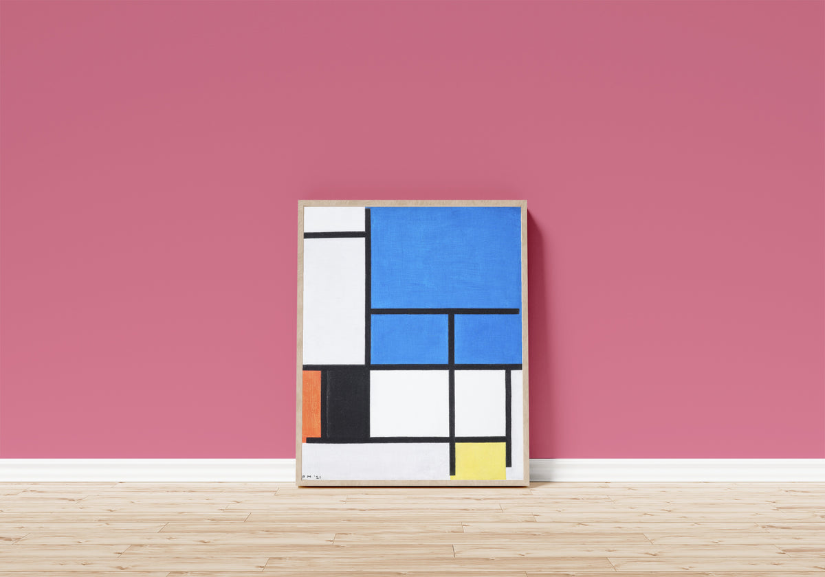 Framed art print of Composition with Large Blue Plane by Piet Mondrian, in a light wood frame leaning on a pink wall above a wooden floor