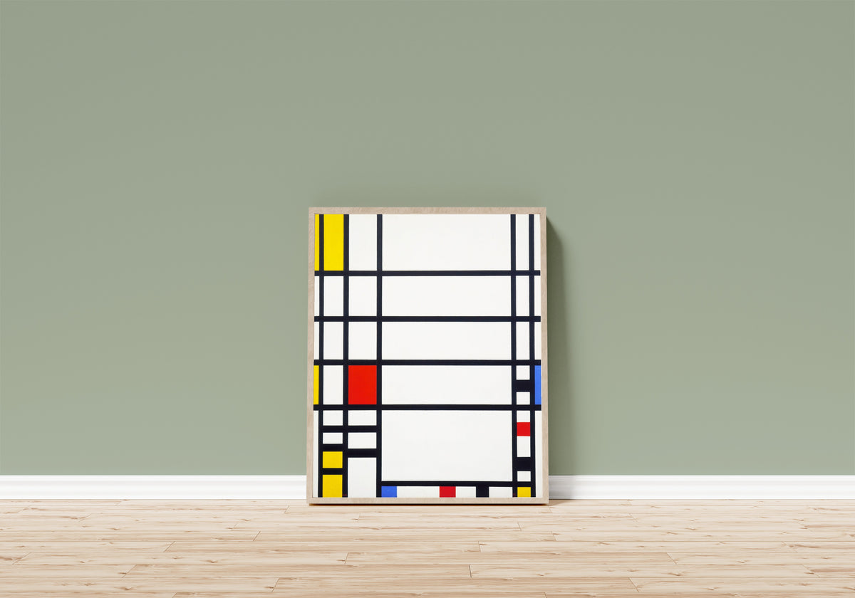 Framed art print of Trafalgar Square by Piet Mondrian, in a light wood frame leaning on a sage green wall above a wooden floor